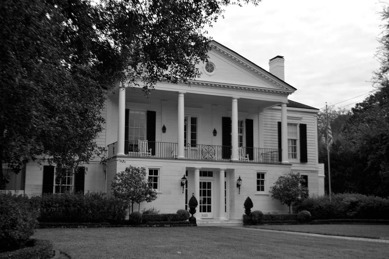 Large oak shading a lawn in front of a house